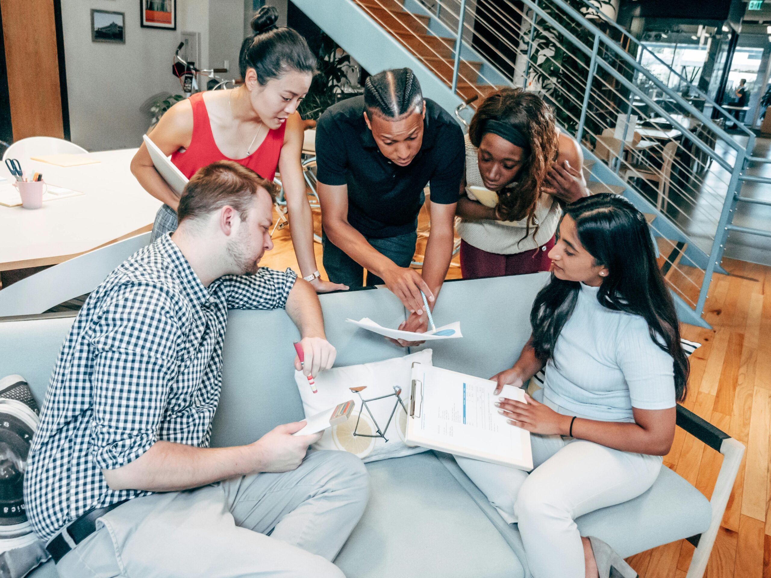 Dynamic group of colleagues brainstorming and working together in an office setting.